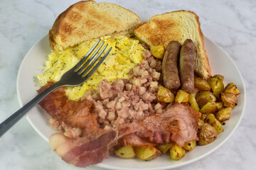 scramble eggs  with sausage, bacon and home fries