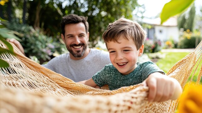 A father and son share a joyful moment relaxing in a hammock in their backyard, highlighted by sunlight filtering through the trees, emphasizing peaceful, familial leisure.