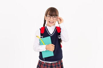 A cute schoolgirl in school uniform holds notebook and pen in her hand.