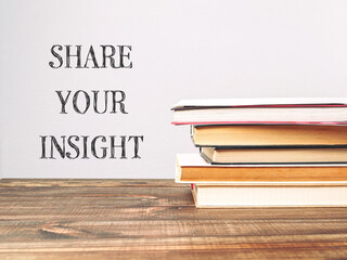 A stack of books with the words share your insight written on top