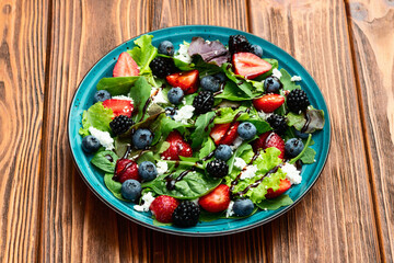 Berries salad (blueberry strawberry blackberry ) with cheese feta and balsamic sauce