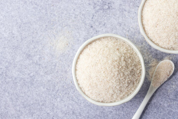 spyllium husk in white ceramic  bowl, healthy eating supplements and superfood