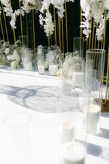 The wedding arch is decorated with flowers and candles.
