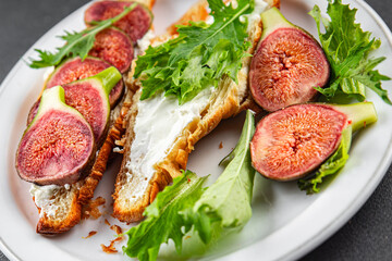 Fig sandwich croissant, cream cheese fresh meal food snack on the table copy space food background rustic top view
