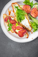Fig sandwich croissant, cream cheese fresh meal food snack on the table copy space food background rustic top view