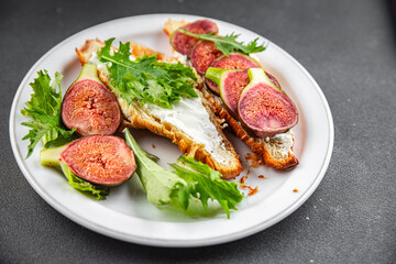 Fig sandwich croissant, cream cheese fresh meal food snack on the table copy space food background rustic top view