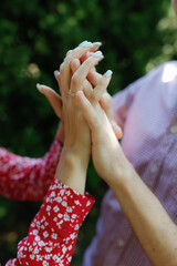 The lovers hold hands, no faces visible.