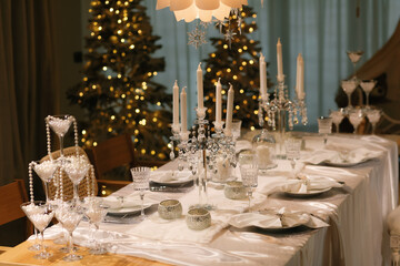 Beautiful glasses with pearls on the festive table. Christmas dinner.
