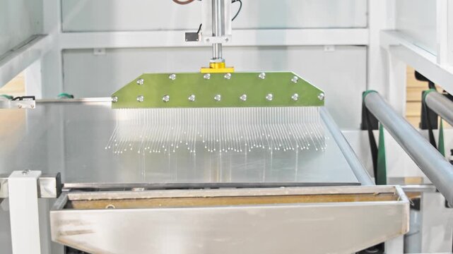 Detailed view of a machine meticulously applying adhesive to furniture components, ensuring an even distribution for optimal results.