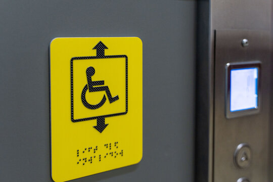 Modern elevator control panel with disabled access and emergency call button in stainless steel interior. An inclusive society. Accessible environment