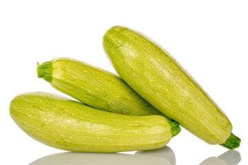 Three ripe zucchini, macro, isolated on white background.
