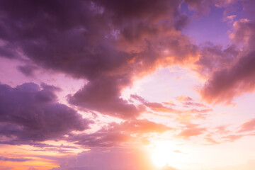 Colorful clouds and sky. Dusk and sunset. Evening clouds with orange, yellow, pink and red sunlight and amazing storm clouds in the dusk sky.