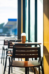 Iced coffee on a table outside the cafe and morning sunlight,Summer, vacation and iced coffee frappe at the beach