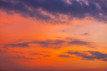 Obraz premium Colorful clouds and sky. Dusk and sunset. Evening clouds with orange, yellow, pink and red sunlight and amazing storm clouds in the dusk sky.