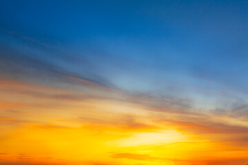 Fototapeta premium Colorful clouds and sky. Dusk and sunset. Evening clouds with orange, yellow, pink and red sunlight and amazing storm clouds in the dusk sky.