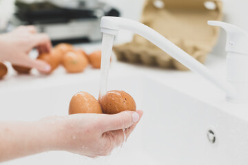 Washing chicken  eggs under  water