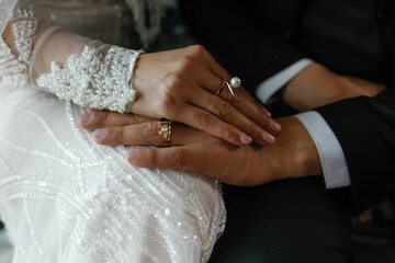 The hands of the newlyweds, the gentle touches, the golden rings.