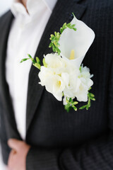 A gorgeous boutonniere on the groom's chest.