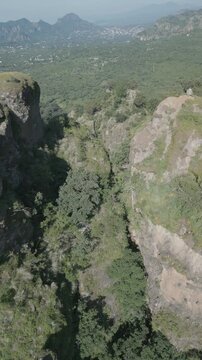 Vertical drone video. Rock formations, forested mountains and large formations. Hiking through the green forest. Hiking concept. Amatlan, Mexico
