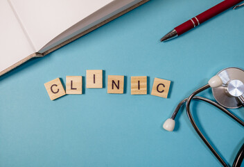 A blue background with a pen and a stethoscope