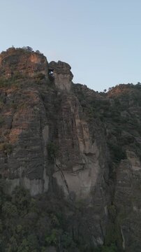 Vertical drone video. Rock formations, forested mountains and large formations. Hiking through the green forest. Hiking concept. Amatlan, Mexico
