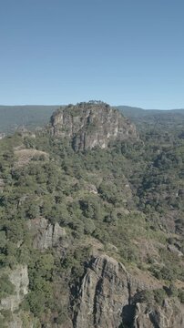 Vertical drone video. Rock formations, forested mountains and large formations. Hiking through the green forest. Hiking concept. Amatlan, Mexico
