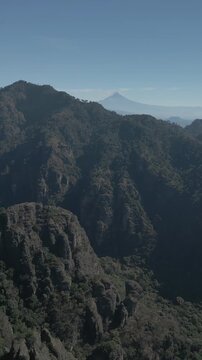 Vertical drone video. Rock formations, forested mountains and large formations. Hiking through the green forest. Hiking concept. Amatlan, Mexico
