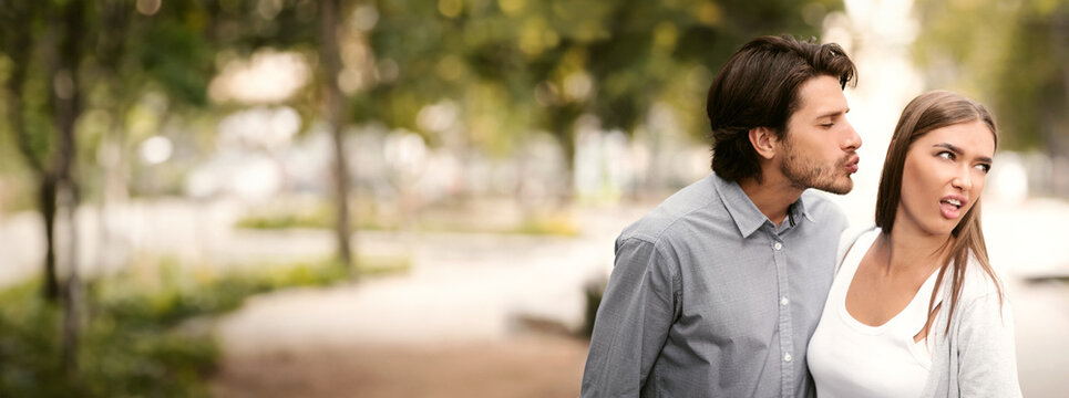Disgusted Woman Rejecting To Kiss Man Having Bad Date Walking Outdoors In Park. Unanswered One-Sided Love Concept