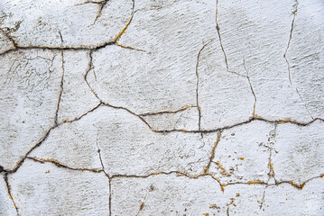 Background photography of aged cracked wall; fence; cement; concrete; grey; abstract; material; obsolete; background; grunge; pattern; textured; crack; peeling; retro; frame