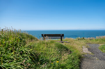 Landscape photography of bench, path, seaview, horizon, viewpoint; scenic; seascape; sunlight, blue sky, destination; hill; travel; Scotland; UK; Portpatrick