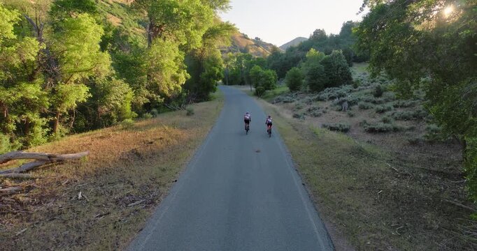 Two professional bikers riding on canyon road - drone shot