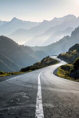 Fototapeta premium A long road in the mountains, winding around and up to mountain peaks