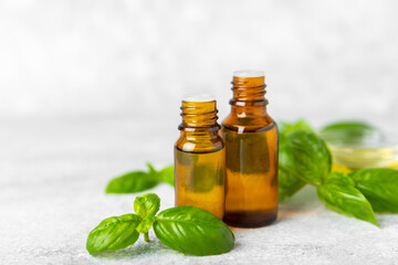 Basil essential oil on a textured wooden background. Basil essential oil and fresh leaves. Aromatherapy. Aroma oil. Medical herbs. Alternative medicine. Place for text. Copy space.