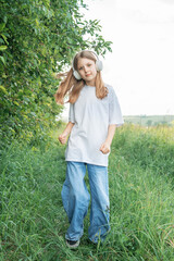 A child  with headphones listening to music and dancing