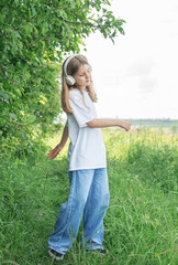 A child  with headphones listening to music and dancing