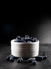 Fresh Honeyberries in a White Cup