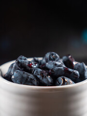 Fresh Honeyberries in a White Cup