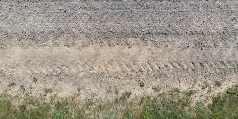 view from above on texture gravel road with median with lawn