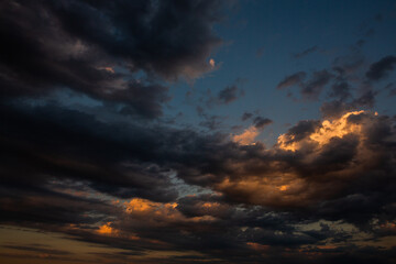 Cloudscape, Colored Clouds at Sunset near the Ocean in a Cloudy Day
