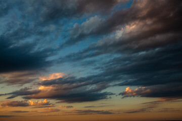 Cloudscape, Colored Clouds at Sunset near the Ocean in a Cloudy Day