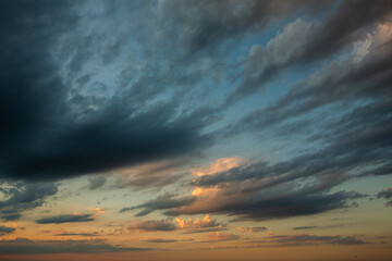 Cloudscape, Colored Clouds at Sunset near the Ocean in a Cloudy Day
