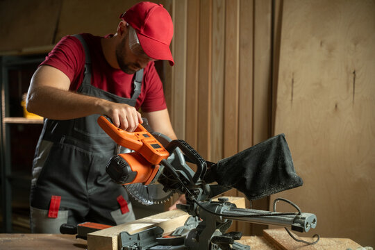 In this instructional session, a person demonstrates how to effectively use a miter saw to create accurate and clean wood cuts. Various techniques are showcased to ensure safety and precision while