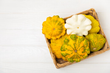 Pattypan zucchini on a textured kitchen table. squash. Fresh organic pattypan squashes on...