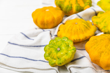 Pattypan zucchini on a textured kitchen table. squash. Fresh organic pattypan squashes on background. Vegan. Farmer's Market. Patisson. Space for text. Copy space.