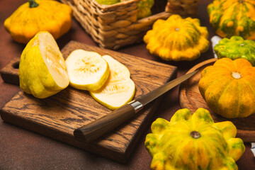Pattypan zucchini on a textured kitchen table. squash. Fresh organic pattypan squashes on...