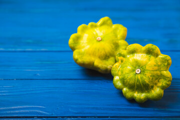 Pattypan zucchini on a textured kitchen table. squash. Fresh organic pattypan squashes on...
