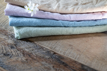 Stack of complementary pastel colors of cotton fabric and tiny white flowers.