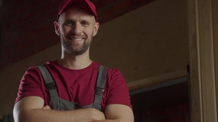 A dedicated carpenter stands proudly in a rustic workshop, showcasing his craftsmanship. Surrounded by wooden tools and materials, he exudes confidence while demonstrating his skills and passion for