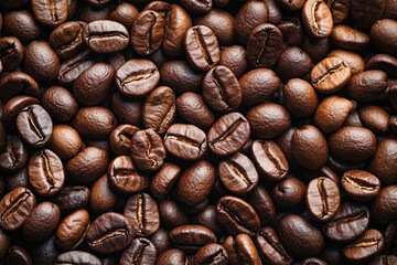 Fototapeta premium A rich layer of coffee beans creates a textured, aromatic background.