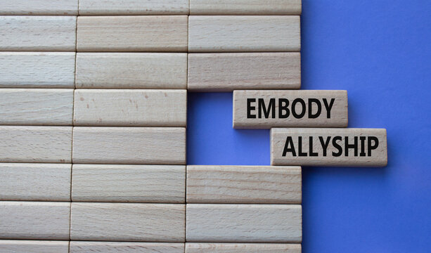 Embody Allyship symbol. Concept word Embody Allyship on wooden blocks. Beautiful purple background. Business and Embody Allyship concept. Copy space